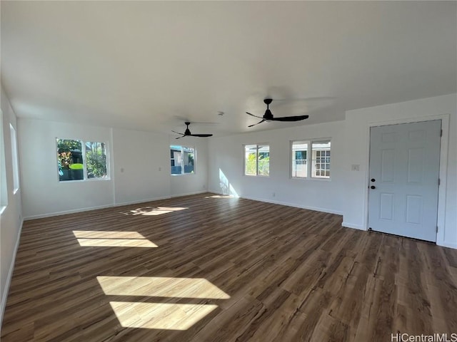 unfurnished living room featuring dark hardwood / wood-style floors, a wealth of natural light, and ceiling fan