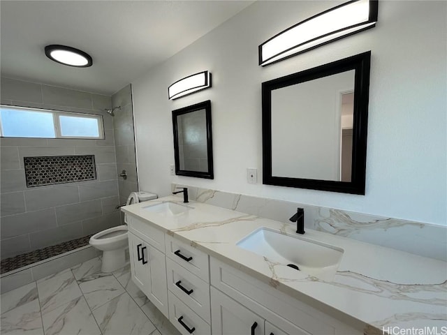 bathroom featuring vanity, toilet, and tiled shower