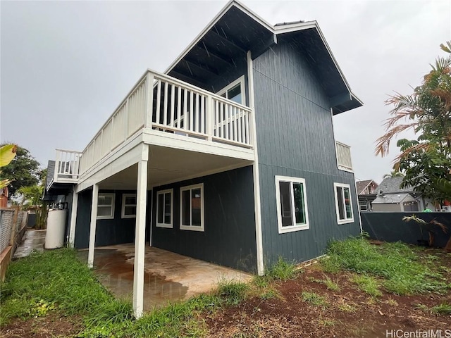 back of house featuring a balcony