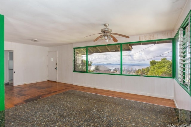 spare room with wood-type flooring and ceiling fan