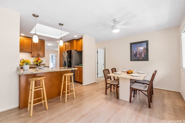 dining room featuring ceiling fan and light wood-type flooring