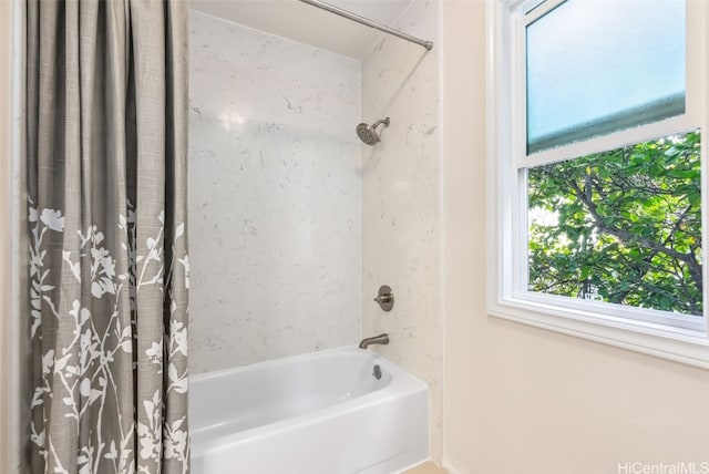 bathroom with shower / bath combo with shower curtain