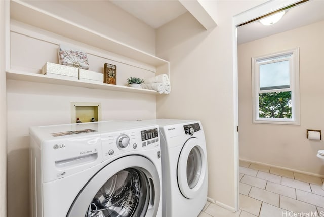 washroom featuring separate washer and dryer and light tile patterned floors