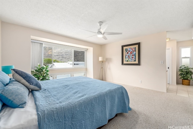 carpeted bedroom featuring multiple windows and a textured ceiling