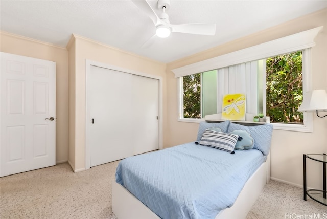 bedroom featuring a closet, multiple windows, ornamental molding, and ceiling fan