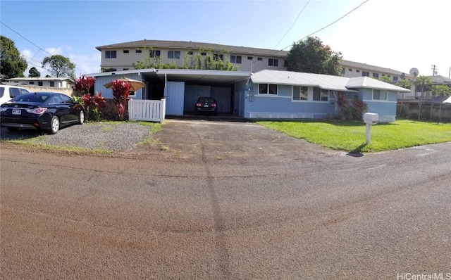 view of front of house featuring a front lawn and a carport