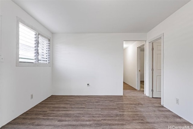 unfurnished room with wood-type flooring