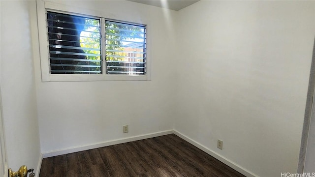 spare room with dark hardwood / wood-style floors