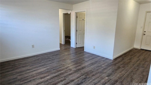 unfurnished room featuring dark hardwood / wood-style flooring