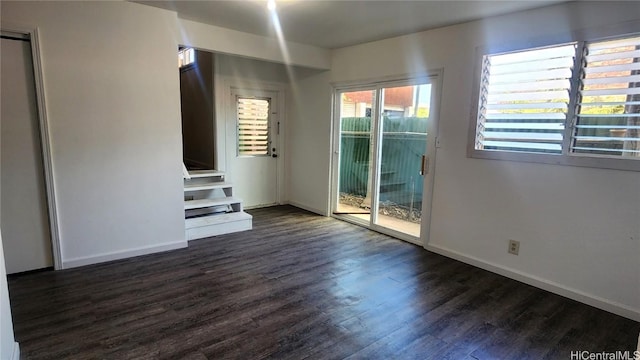 unfurnished living room featuring dark hardwood / wood-style flooring