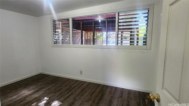 spare room featuring dark wood-type flooring