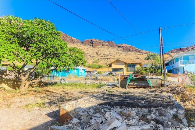 view of yard featuring a deck with mountain view