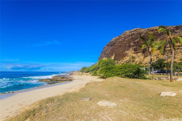 exterior space with a water view and a beach view