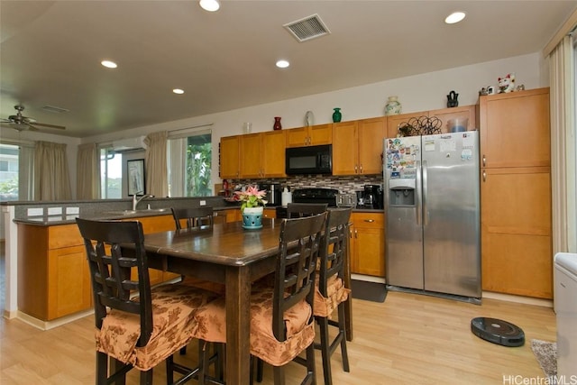 kitchen with black appliances, sink, light hardwood / wood-style flooring, ceiling fan, and tasteful backsplash