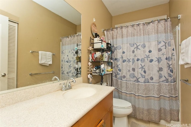 bathroom with a shower with curtain, tile patterned flooring, vanity, and toilet