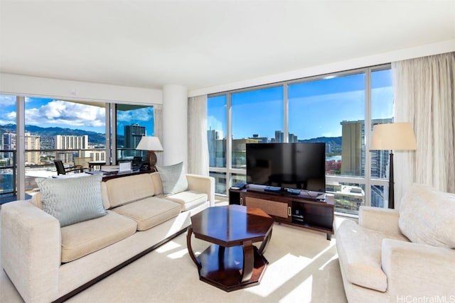 living room with expansive windows and light carpet