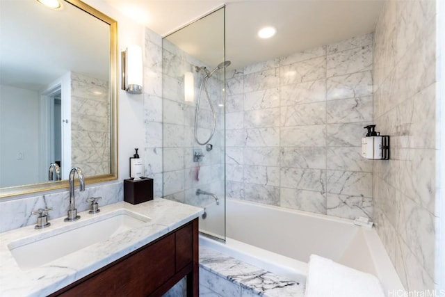 bathroom with vanity and tiled shower / bath combo