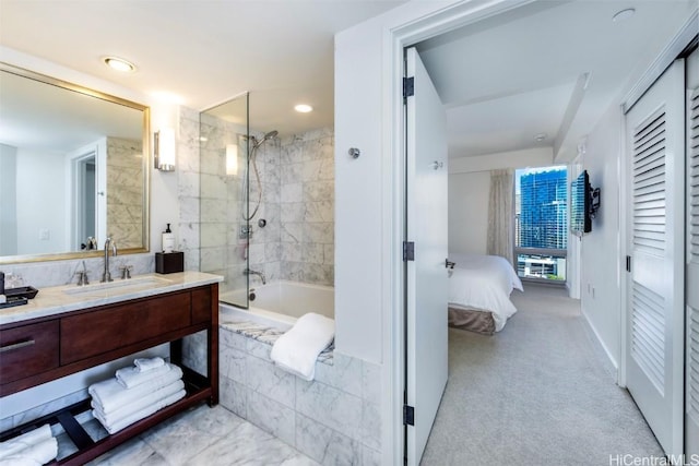 bathroom featuring vanity and tiled shower / bath