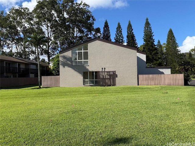 rear view of property featuring a yard