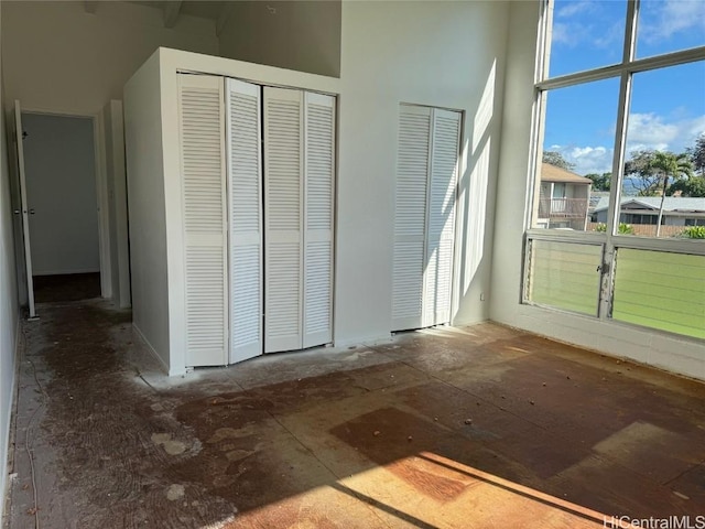 unfurnished bedroom with a towering ceiling