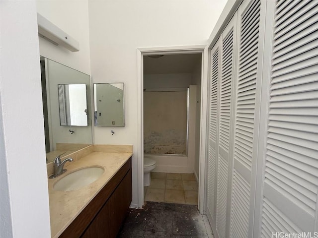 bathroom featuring toilet, vanity, and tile patterned floors