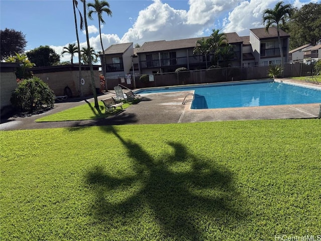 view of swimming pool with a lawn and a patio area