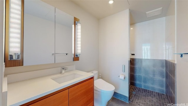 bathroom with toilet, a shower, vanity, and tile patterned floors