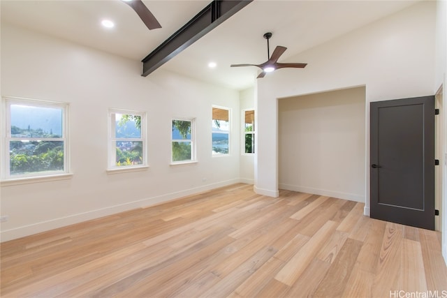 spare room featuring vaulted ceiling with beams, ceiling fan, and light hardwood / wood-style floors