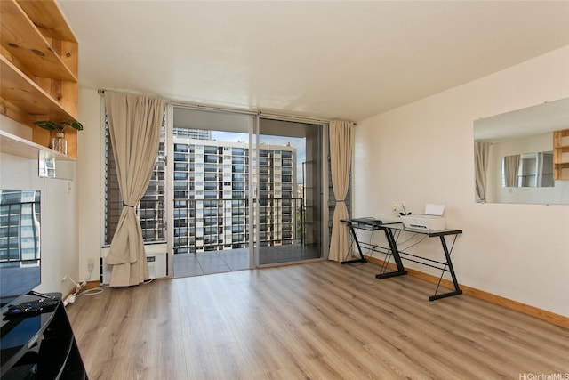 2345 Ala Wai Blvd Unit 1906, Honolulu, HI 96815 - spare room featuring wood finished floors, floor to ceiling windows, and an office area