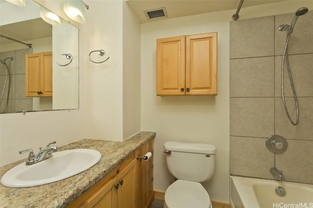 full bathroom with vanity, tiled shower / bath combo, and toilet