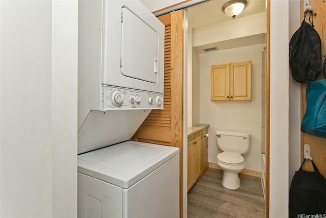 2345 Ala Wai Blvd Unit 1906, Honolulu, HI 96815 - laundry area with estacked washer and dryer and light wood-type flooring