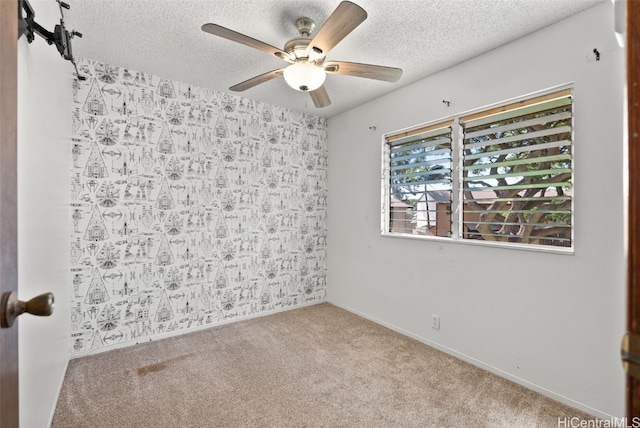 spare room with light carpet, a textured ceiling, and ceiling fan