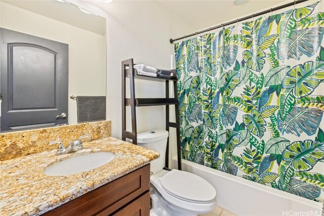 full bathroom featuring vanity, shower / tub combo, and toilet