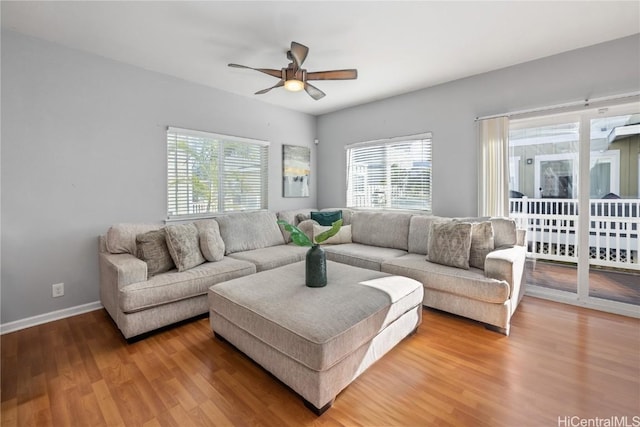 living room with ceiling fan, hardwood / wood-style flooring, and a healthy amount of sunlight