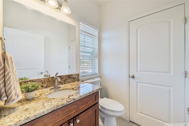 bathroom with vanity, tile patterned floors, and toilet