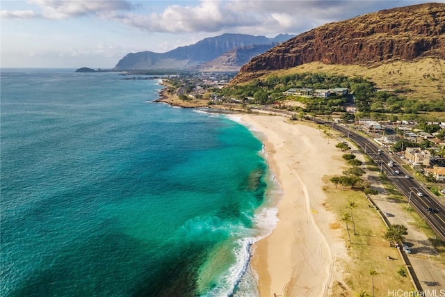 drone / aerial view with a view of the beach and a water and mountain view