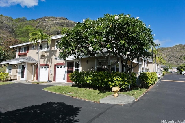 view of front facade with a mountain view and a garage