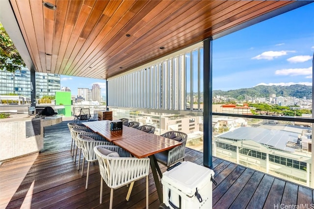 sunroom / solarium with a mountain view and wood ceiling