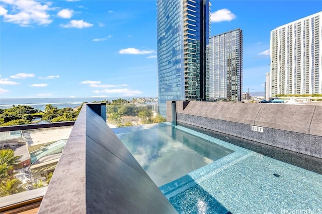 view of pool featuring a water view