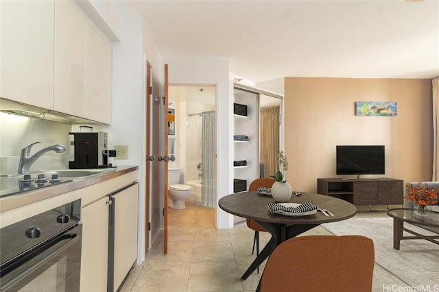 living room with light tile patterned floors and sink