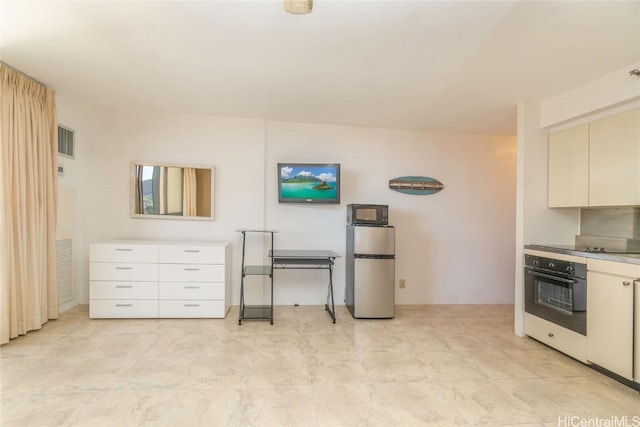 kitchen with white cabinets and appliances with stainless steel finishes