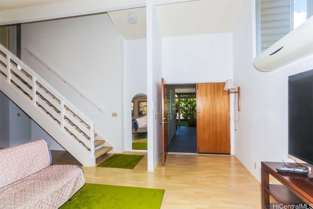 entrance foyer featuring a high ceiling and light hardwood / wood-style flooring