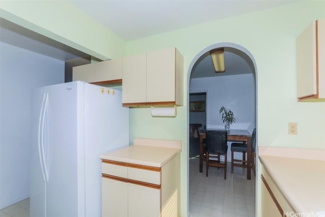 kitchen featuring white cabinets and white refrigerator