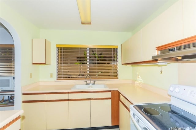 kitchen with exhaust hood, white appliances, and sink