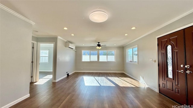 entryway with hardwood / wood-style flooring, ornamental molding, a wealth of natural light, and a wall unit AC