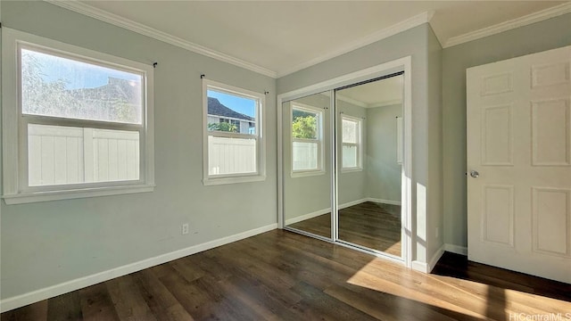 unfurnished bedroom with crown molding, dark hardwood / wood-style flooring, and a closet