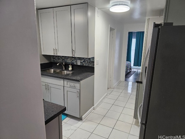 kitchen with refrigerator, sink, gray cabinets, tasteful backsplash, and light tile patterned flooring