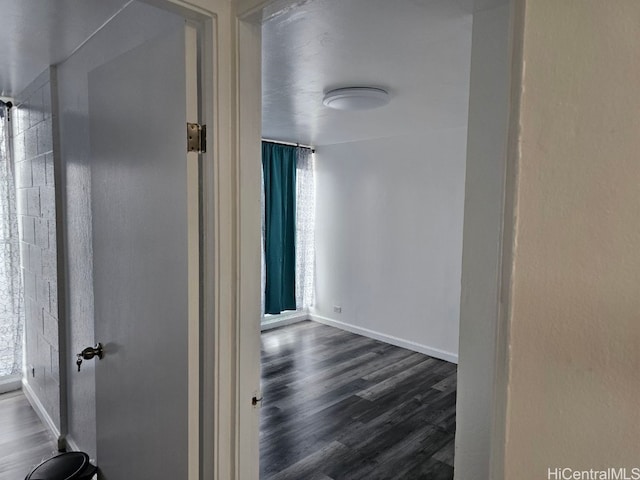 hallway with dark hardwood / wood-style floors