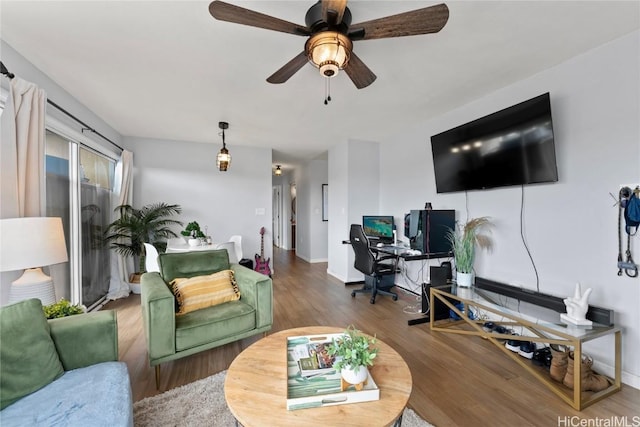 living room with ceiling fan and wood-type flooring