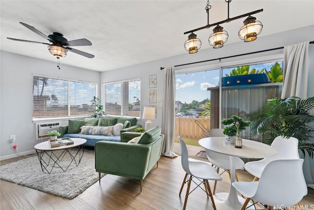 sunroom featuring an AC wall unit and ceiling fan